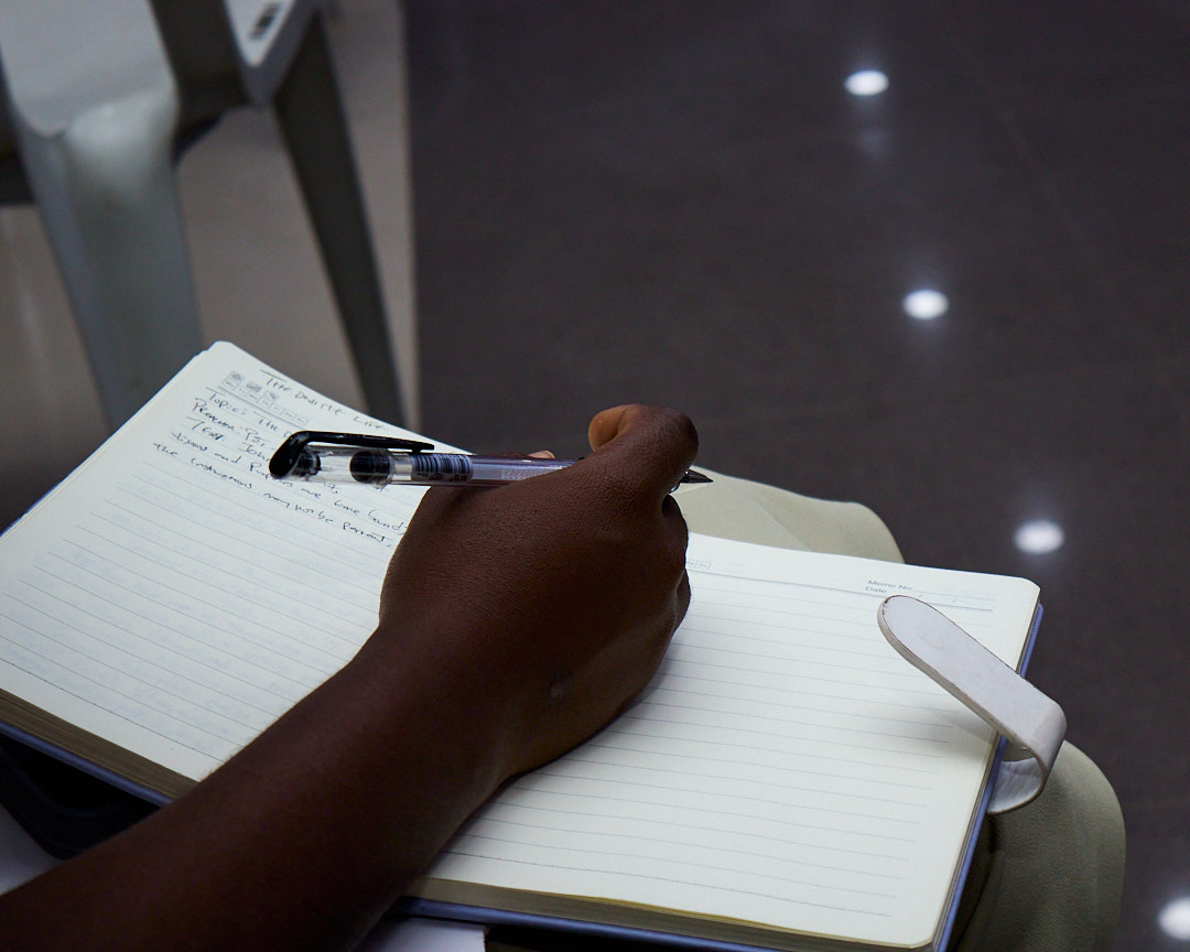 Writing notes during the conference